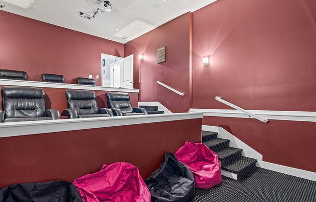 a waiting room with chairs and bags on the floor