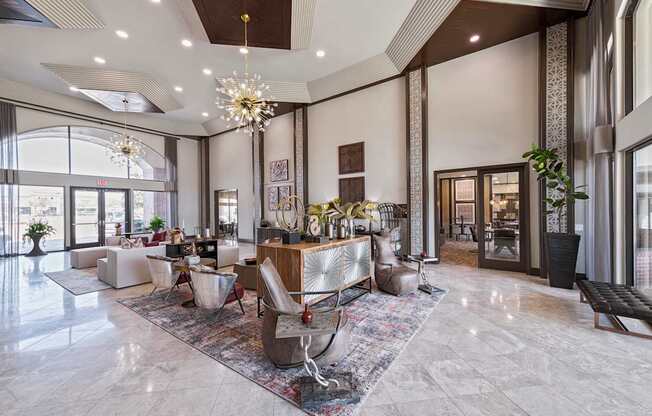 A large, well-lit room with a marble floor and a variety of seating options.