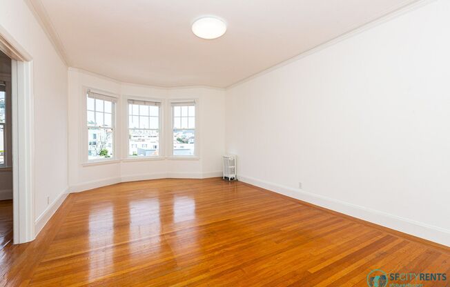 Sunset: Large Top Floor Studio Apartment with Onsite Laundry, Optional Parking, & City Views