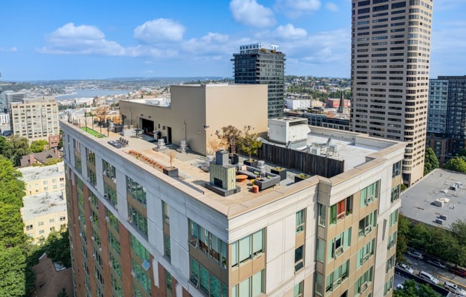 an aerial view of a tall building with a city in the background