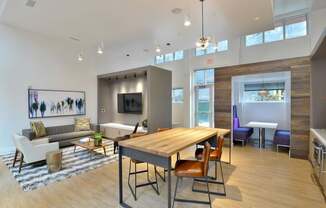 A modern living room with a wooden table and chairs.
