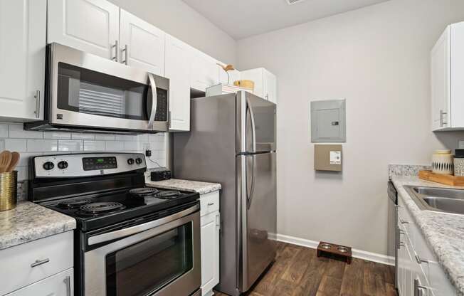 a kitchen with stainless steel appliances and white cabinets