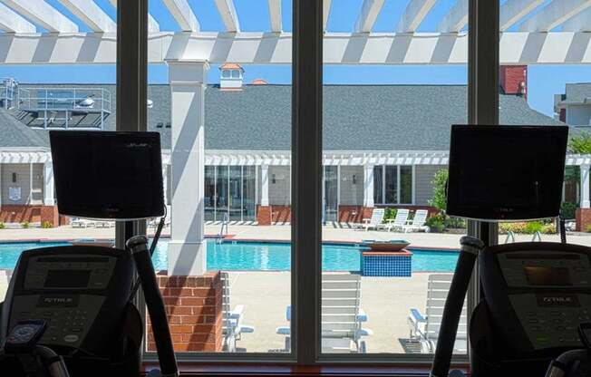 fitness center has a view of the pool at 1200 Acqua Luxury Apartments in Petersburg