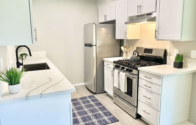 a kitchen with stainless steel appliances and a counter top at BLVD Apartments LLC, California, 91356