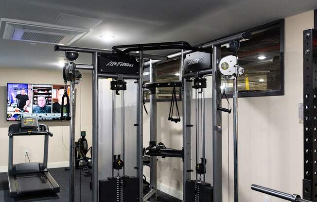 a fitness room with exercise equipment in a home gym