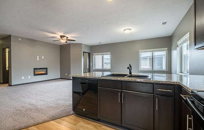 Interiors- A kitchen that opens up to a large living space at the Villas of Omaha at Butler Ridge in Omaha Nebraska