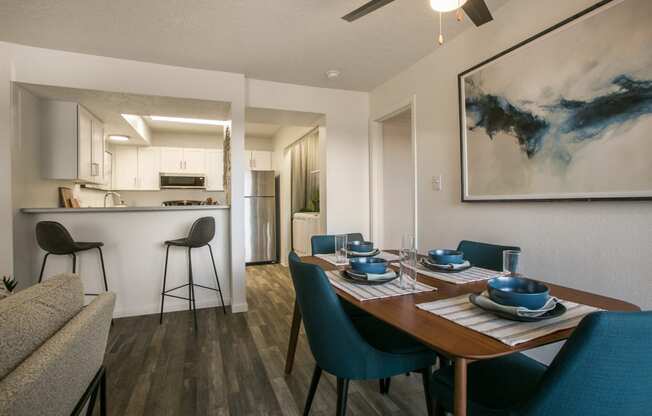 a dining room and kitchen with a table and chairs
