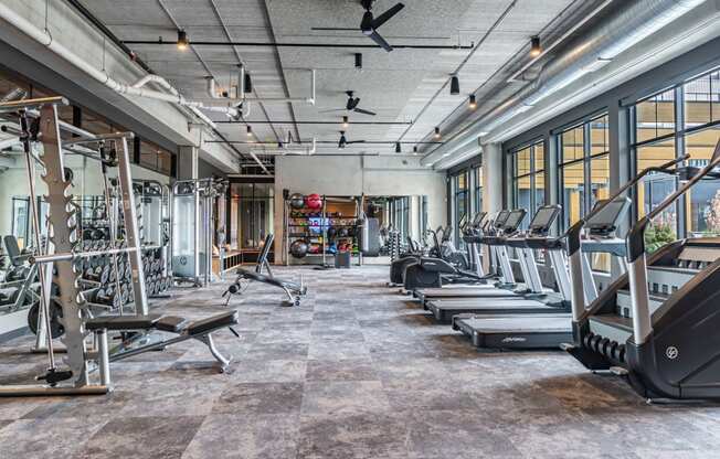 Apartments for Rent in Bloomington, MN - Carbon31 - Fitness Center with Treadmills, Training Machines, Weight Lifting Equipment, Large Windows, and Ceiling Fans