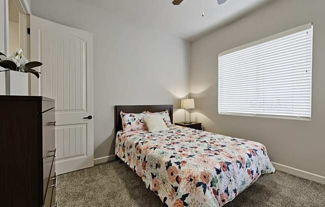 a bedroom with a bed and a ceiling fan