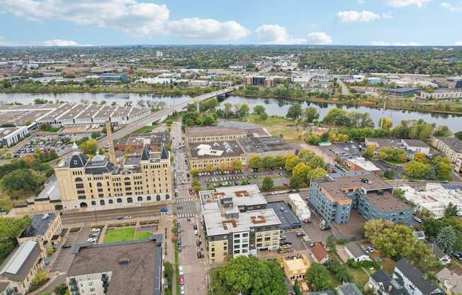 A cityscape with a large building in the center and a river running through it.