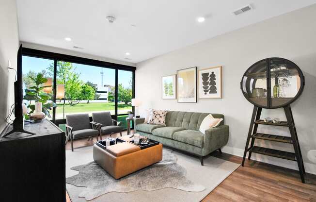 a living room with a couch and chairs and a large window