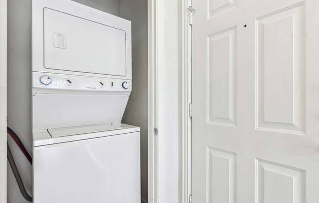 a laundry room with a washer and dryer next to a door