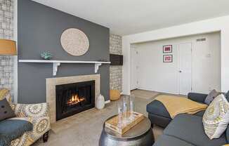 a living room with a fireplace and couches