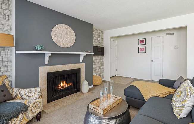 a living room with a fireplace and couches