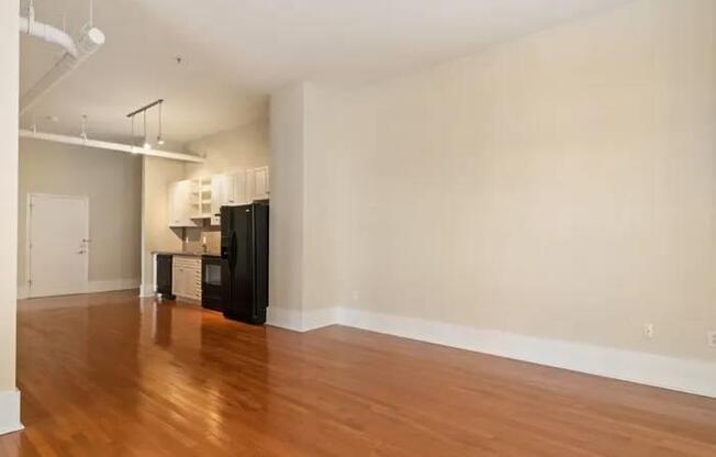 A room with wooden floors and white walls.