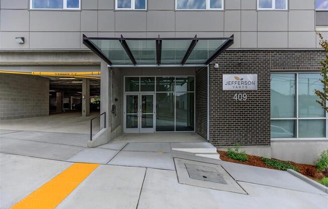 a large building with an entrance and a sign that says university of pittsburgh at Jefferson Yards, Tacoma Washington