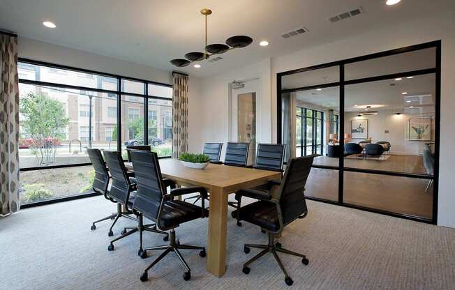 A conference room with a long table and chairs.