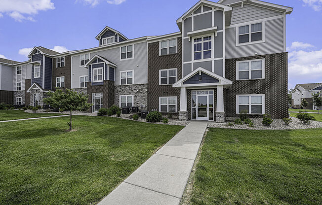 well maintained apartment building with grass at Trade Winds Apartment Homes in Elkhorn, NE 68022