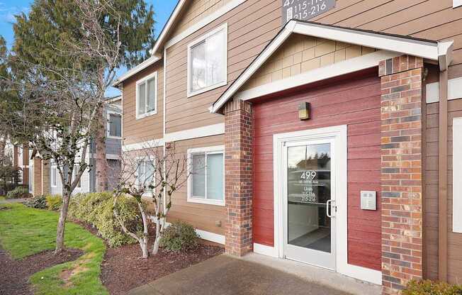 A building with a red and beige facade has a number 499 on it.