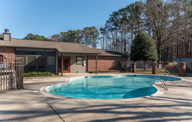 A small pool in front of a house.