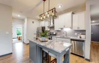A modern kitchen with a large island in the center.