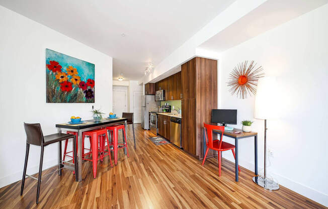 a living room with a table and chairs and a kitchen