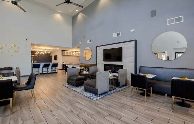 A modern clubhouse with a fireplace and bar area in the background.