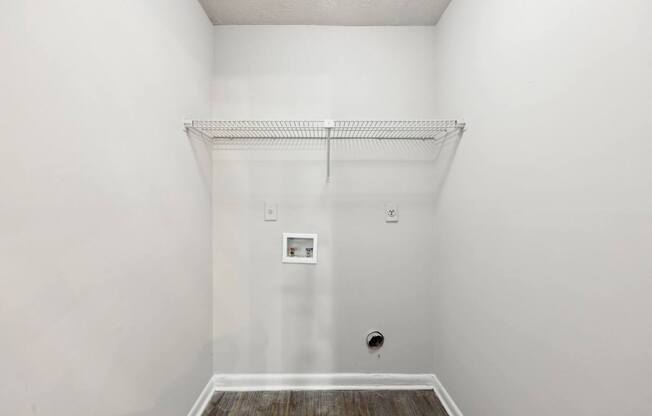 A closet with a shelf and clothes rod at Gwinnett Square Apartments in Duluth, GA