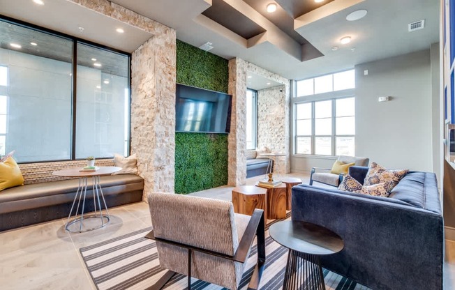 A living room with a couch, a chair, and a table.