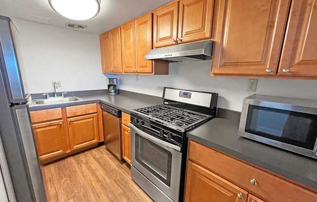 A kitchen with wooden cabinets and stainless steel appliances.
