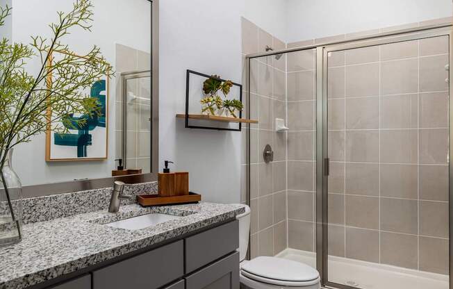 Rhythm Bathroom with Large Shower and Quartz Countertop Vanity