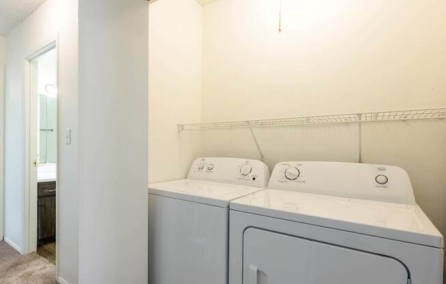 A laundry room with a washer and dryer at Spring Creek Townhomes Apartments, Illinois