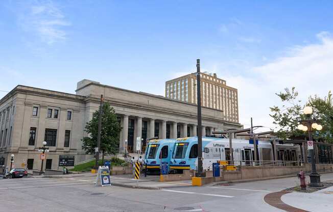 A city bus is parked at a bus stop at Lowertown Commons Apartments, St. Paul, MN, 55101