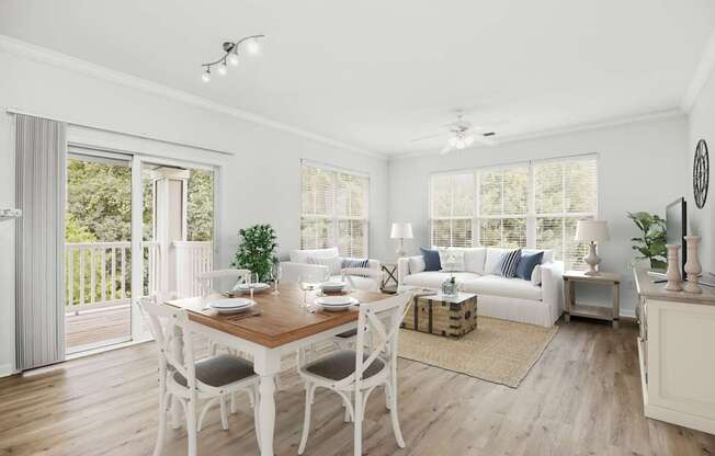 A dining room with a wooden table and white chairs.