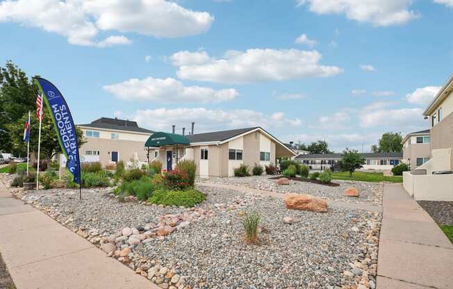 A row of houses with a flag in front.