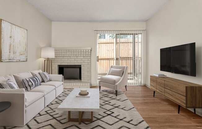 a living room with a white couch and a fireplace and a tv at South Lamar Village, Austin