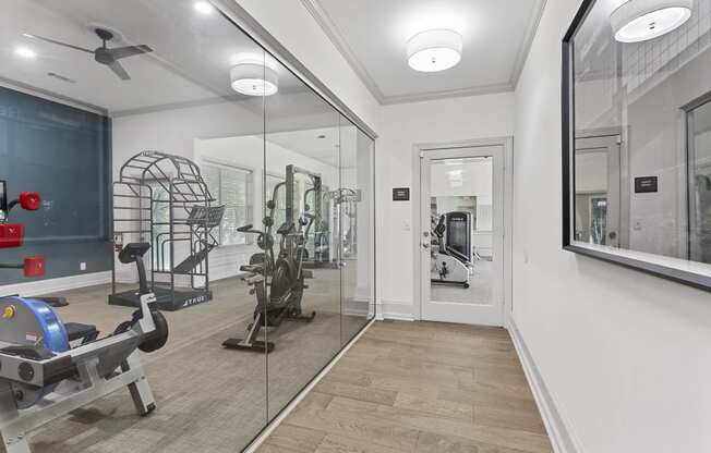 the gym in the owners home is equipped with a treadmill and weights