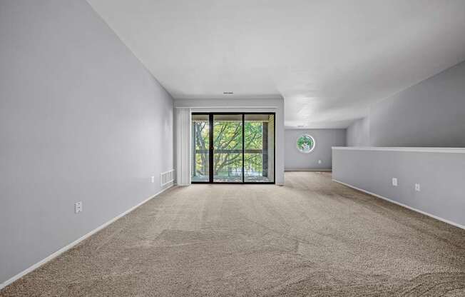 Gorgeous living room with balcony at Park Lane Apartments in Southfield, MI