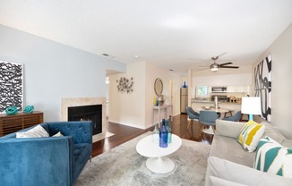 a living room with couches and chairs and a fireplace