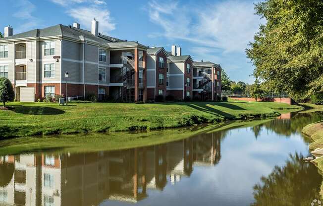 A building with a pond in front of it.