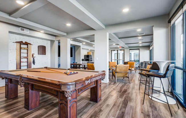 Dog-Friendly Apartments in Phoenix, AZ - Community Clubhouse with Billiards, TV, Seating, and Tables