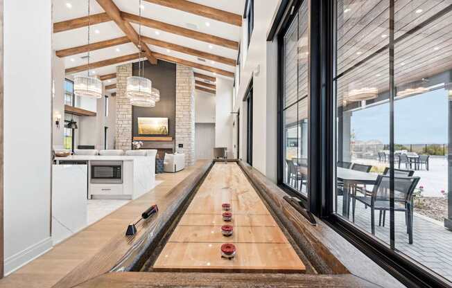 a bowling alley in a living room with a view of the dining room and kitchen