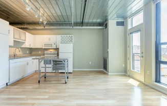 a large kitchen with a table in the middle at Ann Arbor City Club, Michigan, 48104