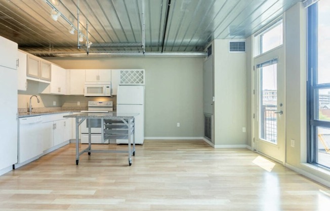 a large kitchen with a table in the middle at Ann Arbor City Club, Michigan, 48104