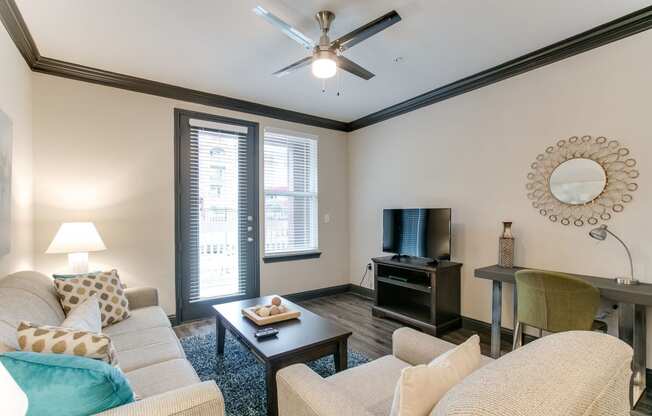 a living room with a ceiling fan and a couch