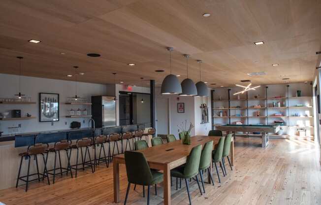 a dining room with tables and chairs and a bar at Sono Central Residential, Norwalk, Connecticut