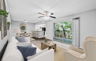 a living room with a white couch and a ceiling fan