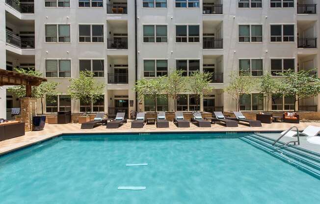 a swimming pool in front of an apartment building