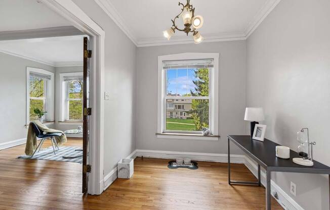 a living room with a window and a table at The Bryant at Oak Park I & II, Oak Park Illinois