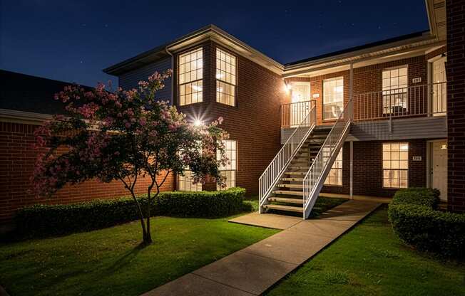 A building with a lit up staircase and windows.